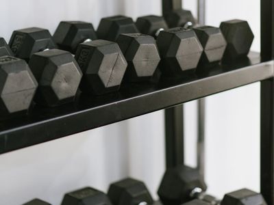 Clean and organized workout space with a yoga mat and weights.