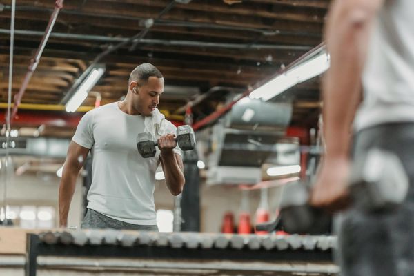 Man focused during a strength training exercise in a modern gym.